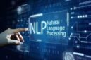 Sebuah tangan menunjuk ke antarmuka digital yang menampilkan teks NLP: Teknik Komunikasi yang Mengubah Cara Berinteraksi, dikelilingi oleh ikon-ikon futuristik dan kode biner dengan latar belakang biru.